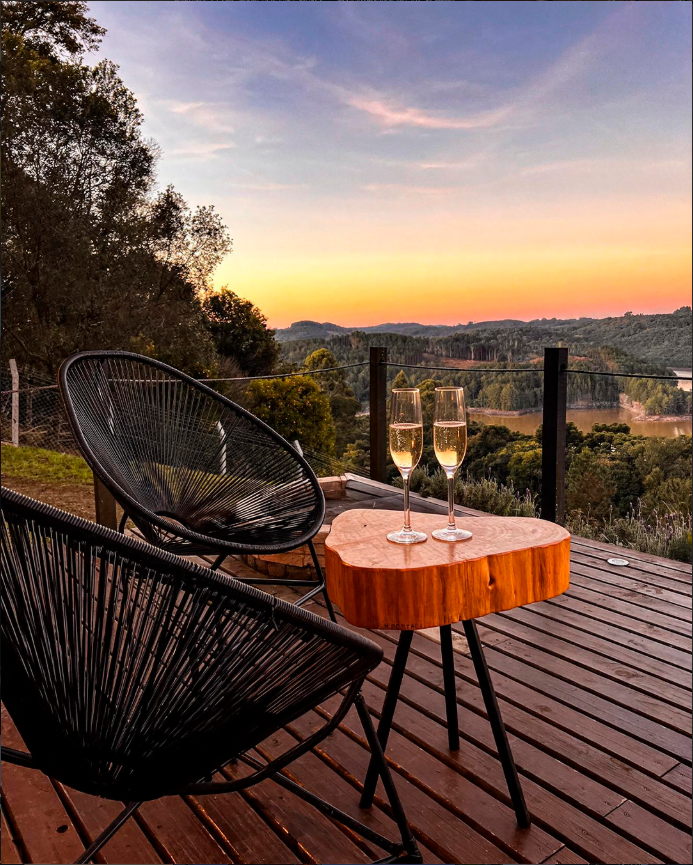 Deck com cadeiras e taças no pôr do sol